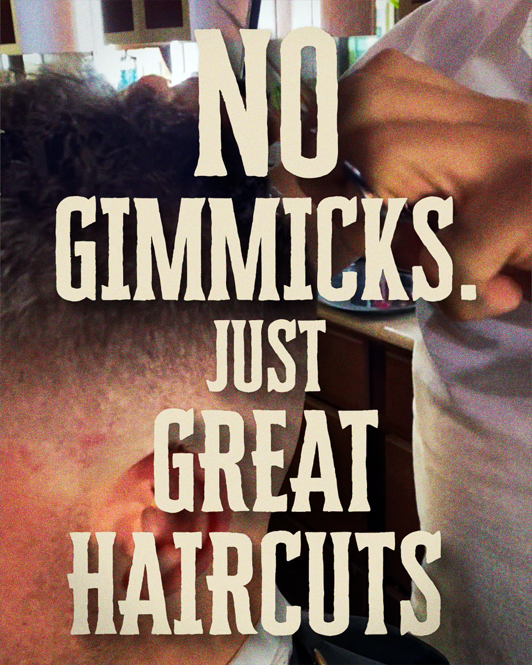 A close up shot of someone getting their haircut serves as the backdrop for ad text.