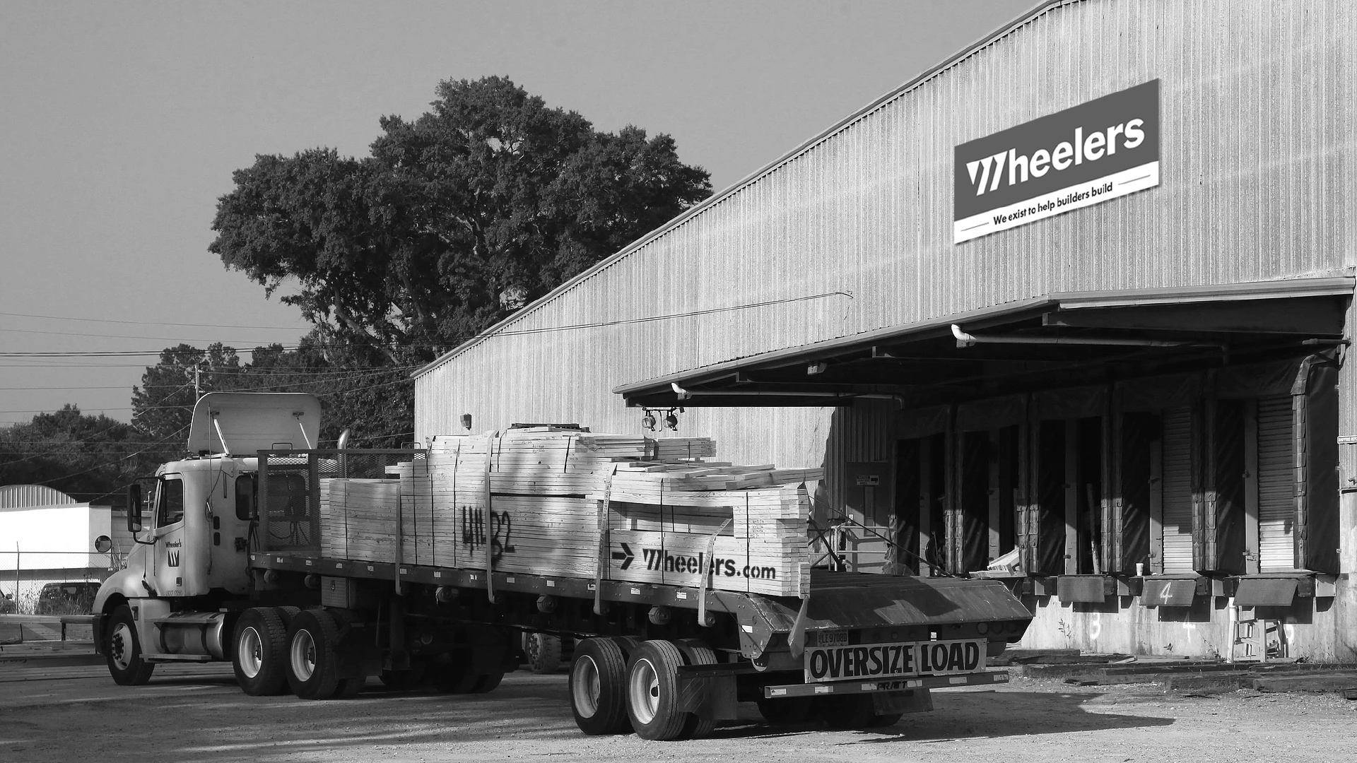 A truck loaded with wood trusses drives away from Wheelers’ manufacturing plant.